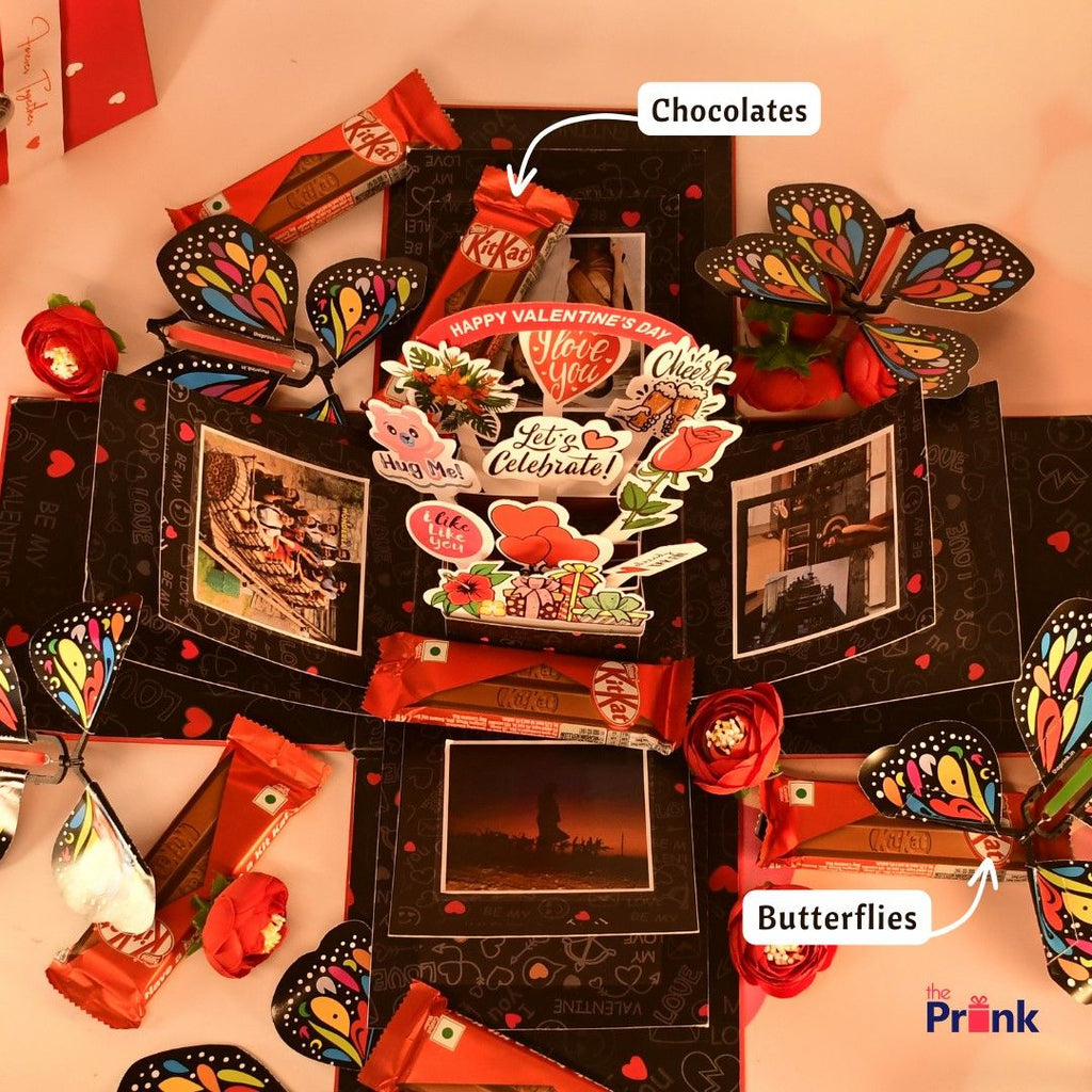 Valentine's Day themed gift box features colorful paper butterflies, decorated messages, chocolates, and photos, creating a festive and romantic display.